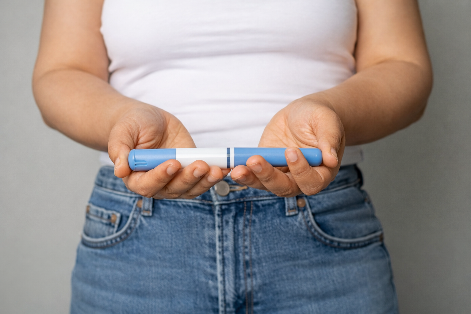 Women with a Wegovy pen in front of her.