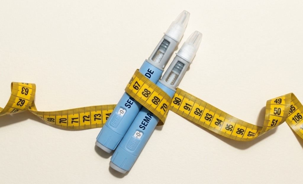 A generic Ozempic semaglutide injection pen next to a tape measure.
